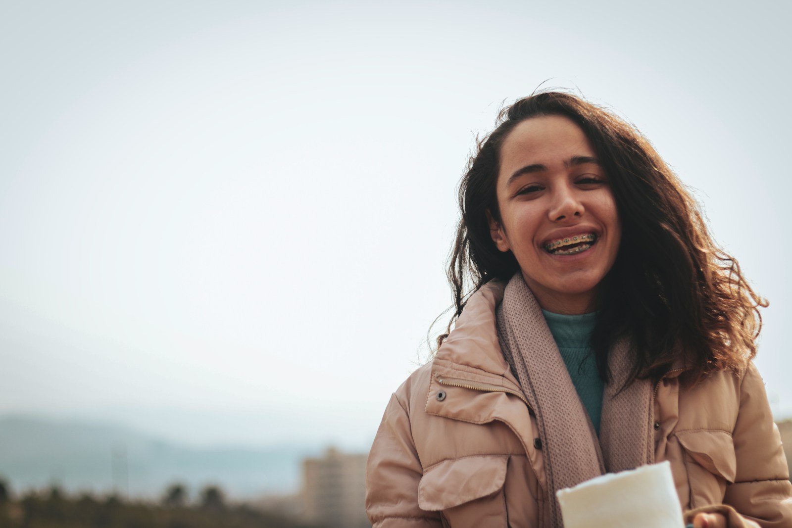 a woman holding a cup of coffee and smiling